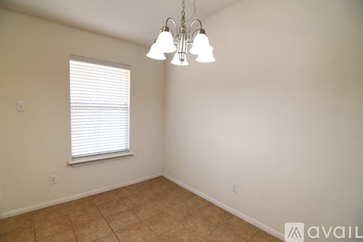 A carpeted room with a door on the right side.