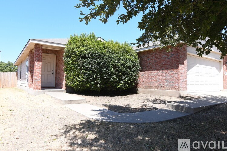 A house with a red brick wall and a white garage door.