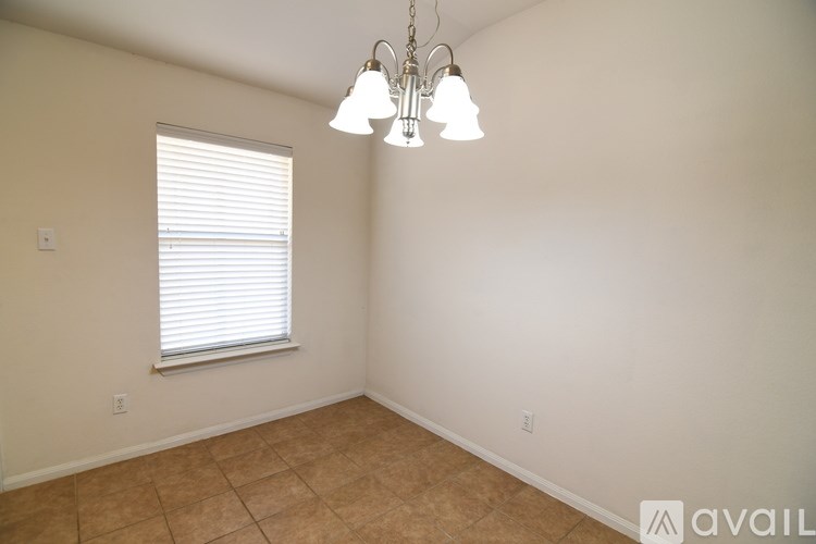 A room with a window and a chandelier.