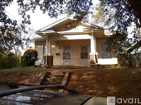 A house with a car parked in front of it.