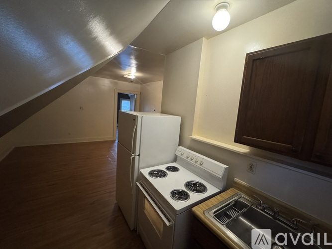 A kitchen with a stove and a refrigerator.