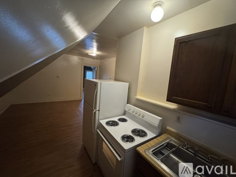 A kitchen with a stove and a refrigerator.