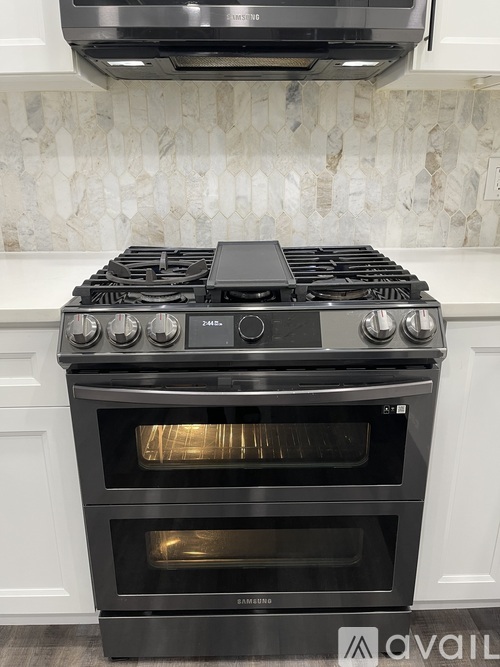 A black stove top oven with four burners and two ovens.