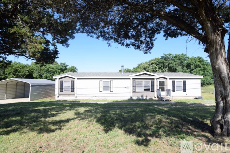 A house with a tree in front of it.