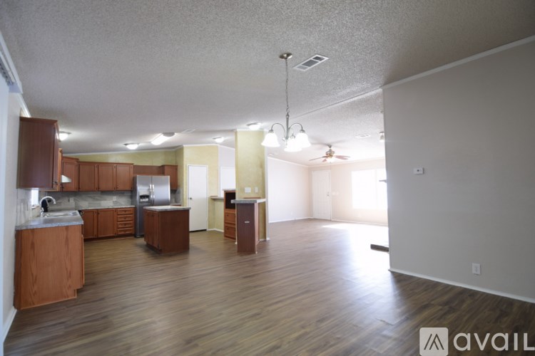A spacious living area with a kitchen and dining area.
