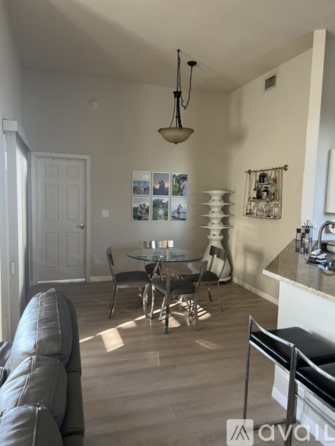 A living room with a grey couch and a black chair.