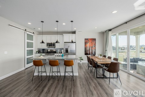 A modern kitchen with a dining table and chairs.