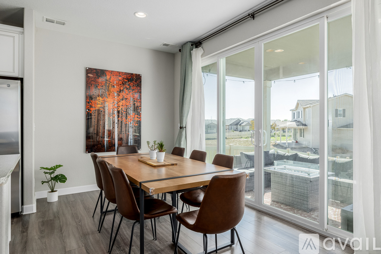 A dining room with a wooden table and chairs.