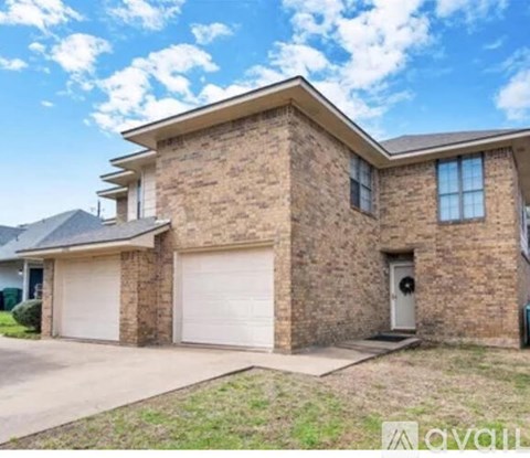 A two-story house with a garage is shown in the image.