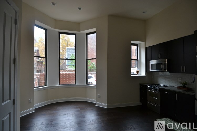 A kitchen with black cabinets and a stove top oven.