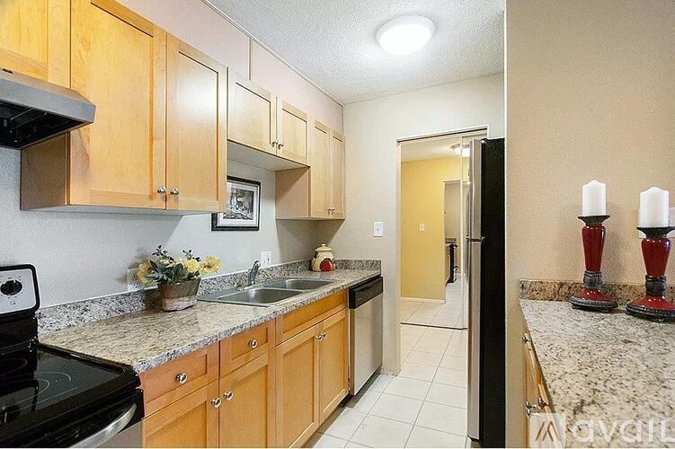 A kitchen with wooden cabinets and granite countertops.