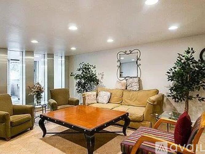 A living room with a wooden table and a mirror on the wall.