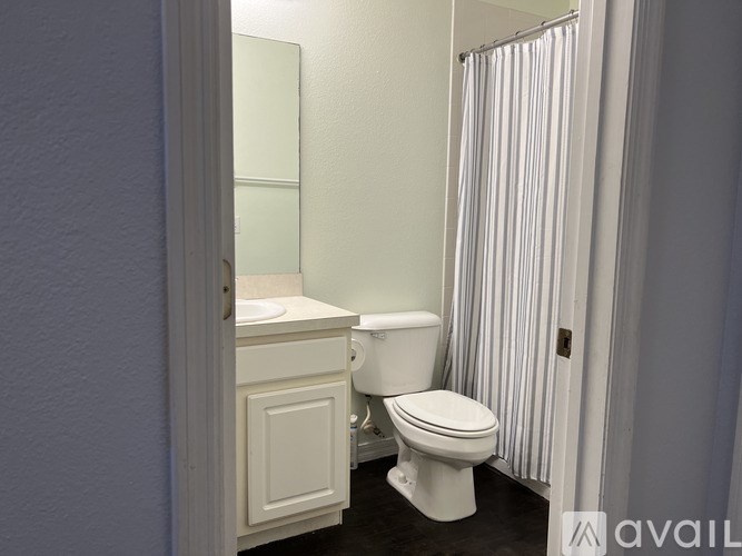 A white toilet sits next to a sink in a bathroom.