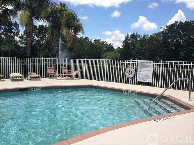 A pool surrounded by a fence with a sign on it.