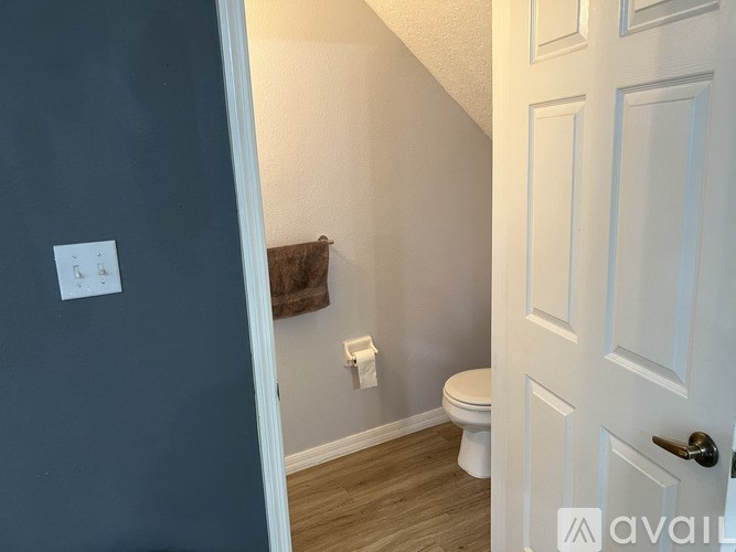 A bathroom with a toilet and a door.