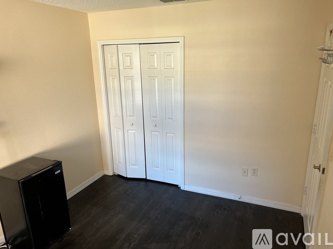 A room with a black speaker and a white door.