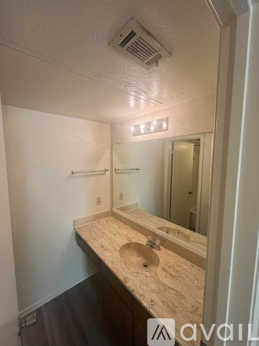 A bathroom with a sink and mirror.