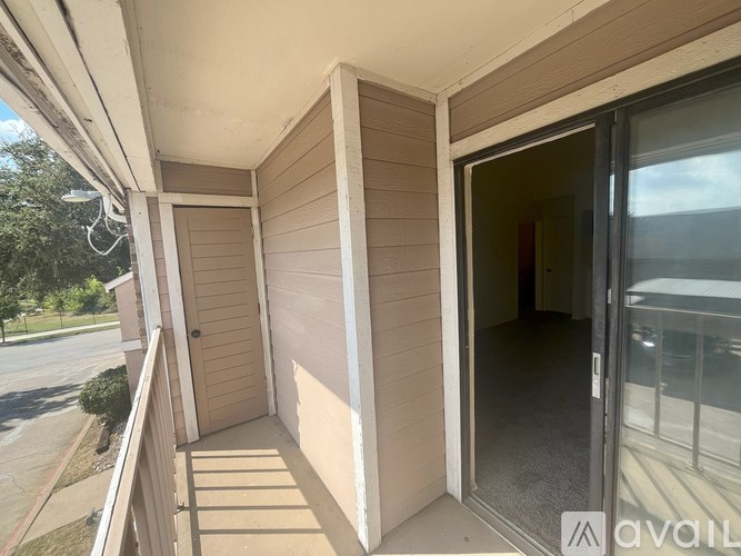 A balcony with a door and a window.