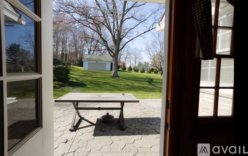 A table is on a patio outside a house.