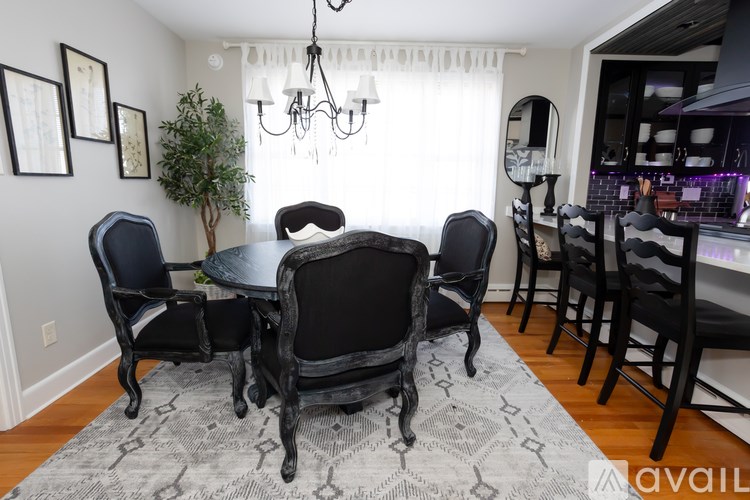 A dining room with a table set for six.
