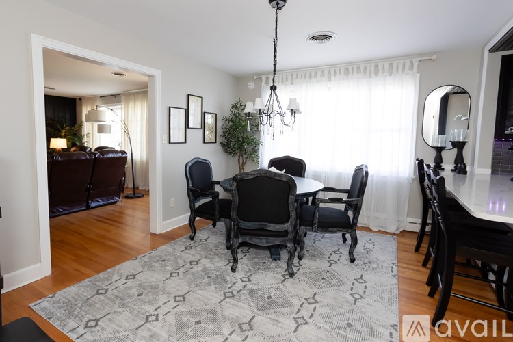 A dining room with a table set for six.