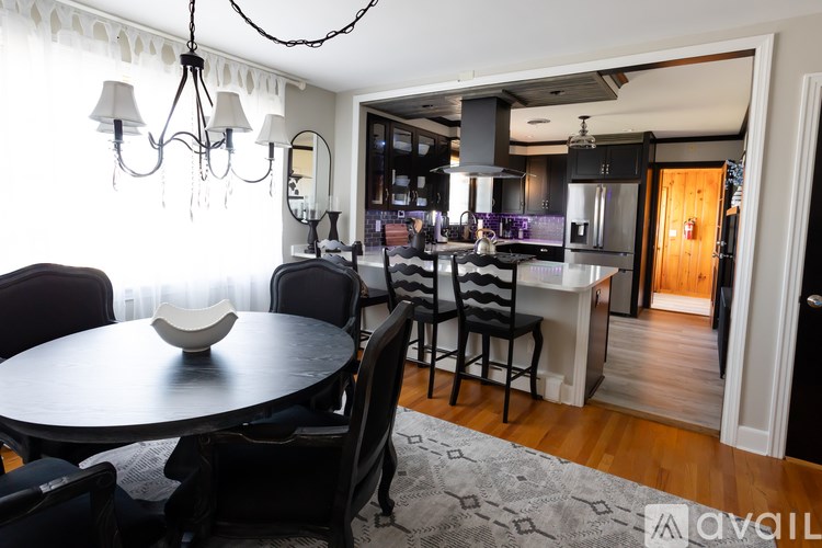 A modern dining room with a round table and chairs.