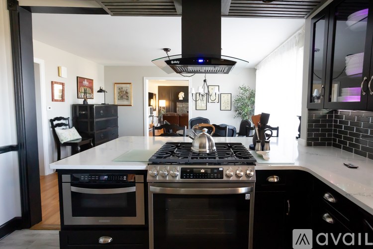 A modern kitchen with a stove top oven and a range hood.