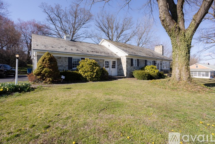 A house with a tree in front of it.