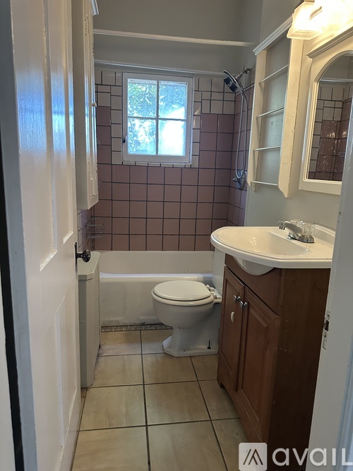 A bathroom with a toilet, sink, and shower.