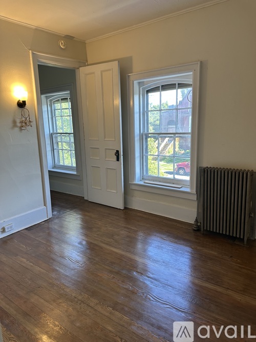 A room with a wooden floor and a window.