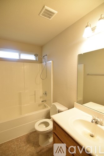 A bathroom with a toilet, sink, and bathtub.
