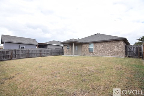 A house with a fence and a grassy yard is available for sale.