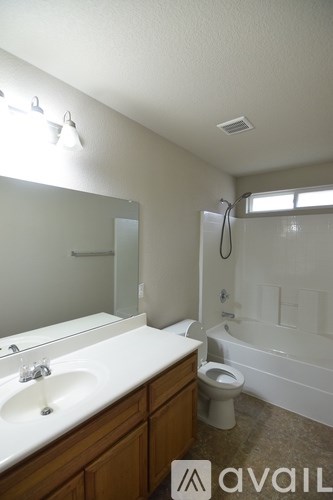A bathroom with a sink, toilet and bathtub.