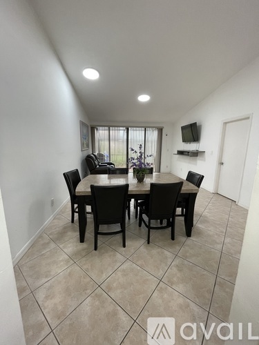 A dining room with a table and chairs.