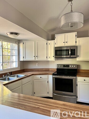 A kitchen with a stove top oven and microwave above it.
