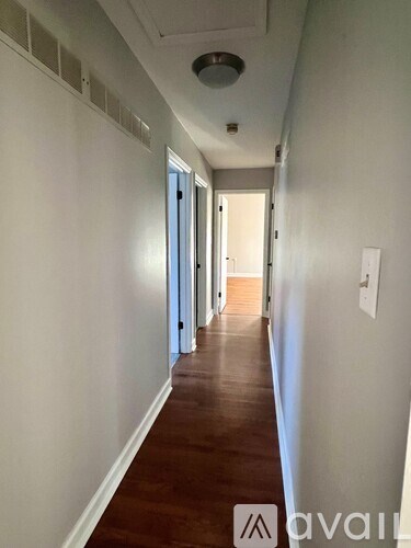 A long hallway with doors on both sides.