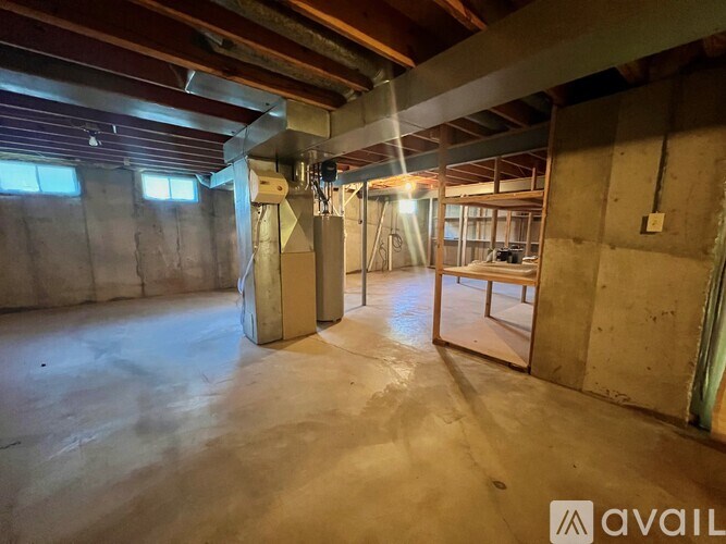 A room under construction with exposed wooden beams and unfinished walls.