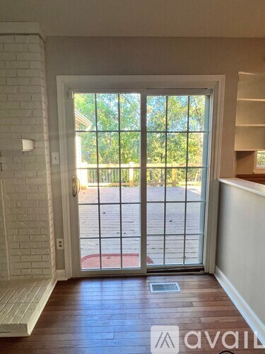 A white door with a glass window leading to a patio.