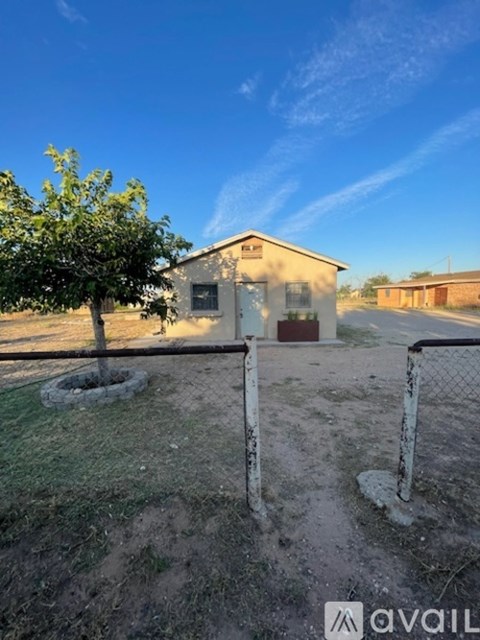 A small building with a tree in front of it.
