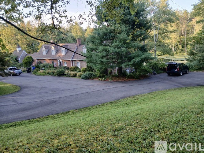 A house with a driveway and a car parked in front.