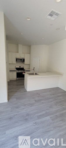 A kitchen with a white countertop and a microwave above it.