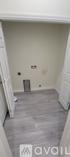 A room with a grey floor and white walls.
