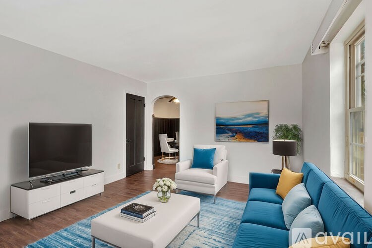 A living room with a white sofa and a television.