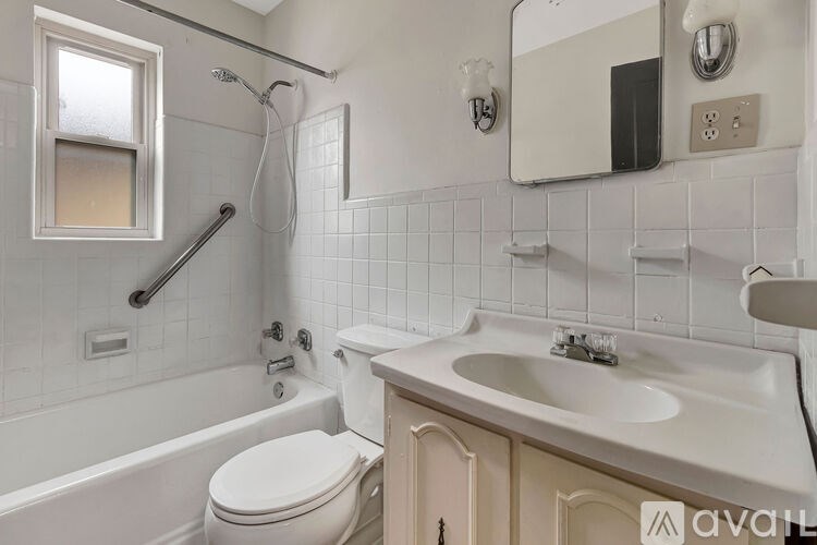 A white bathroom with a toilet, sink, and tub.