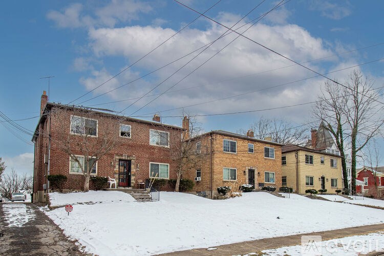 A large house with a snow covered front yard.