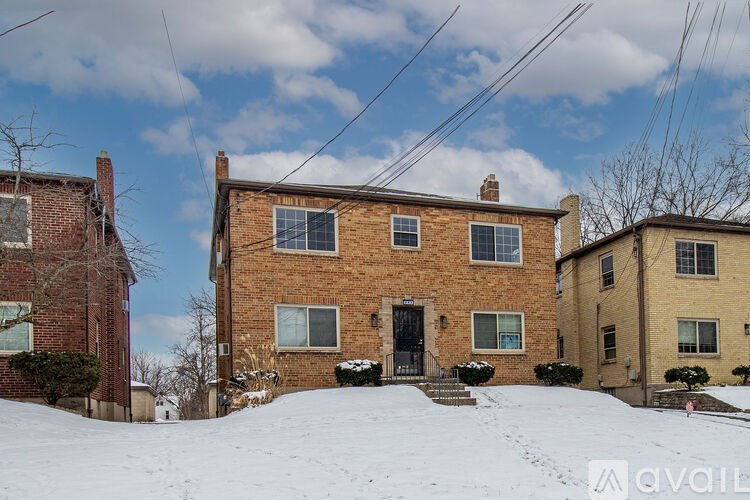 A house with a snow-covered front yard.