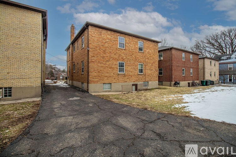 A brick building with a driveway in front of it.