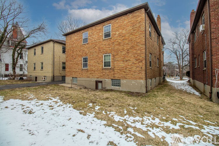 A red brick building with a white door in the center.