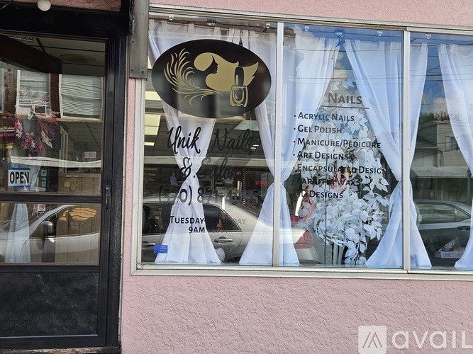 A window display for a nail salon with a sign that reads "Whik Nails & Spa".