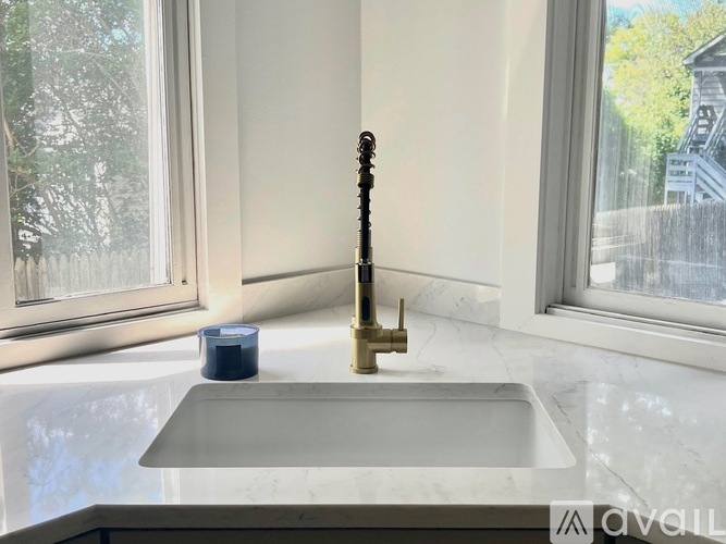 A bathroom sink with a faucet and a candle on the counter.